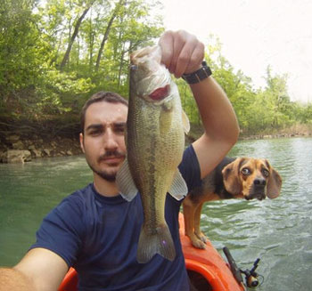 fishing dog photobomb man and fish