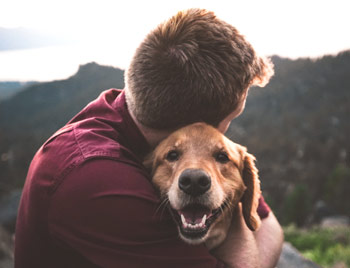 dog and man hugging