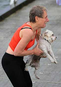 lady hugs her wet dog